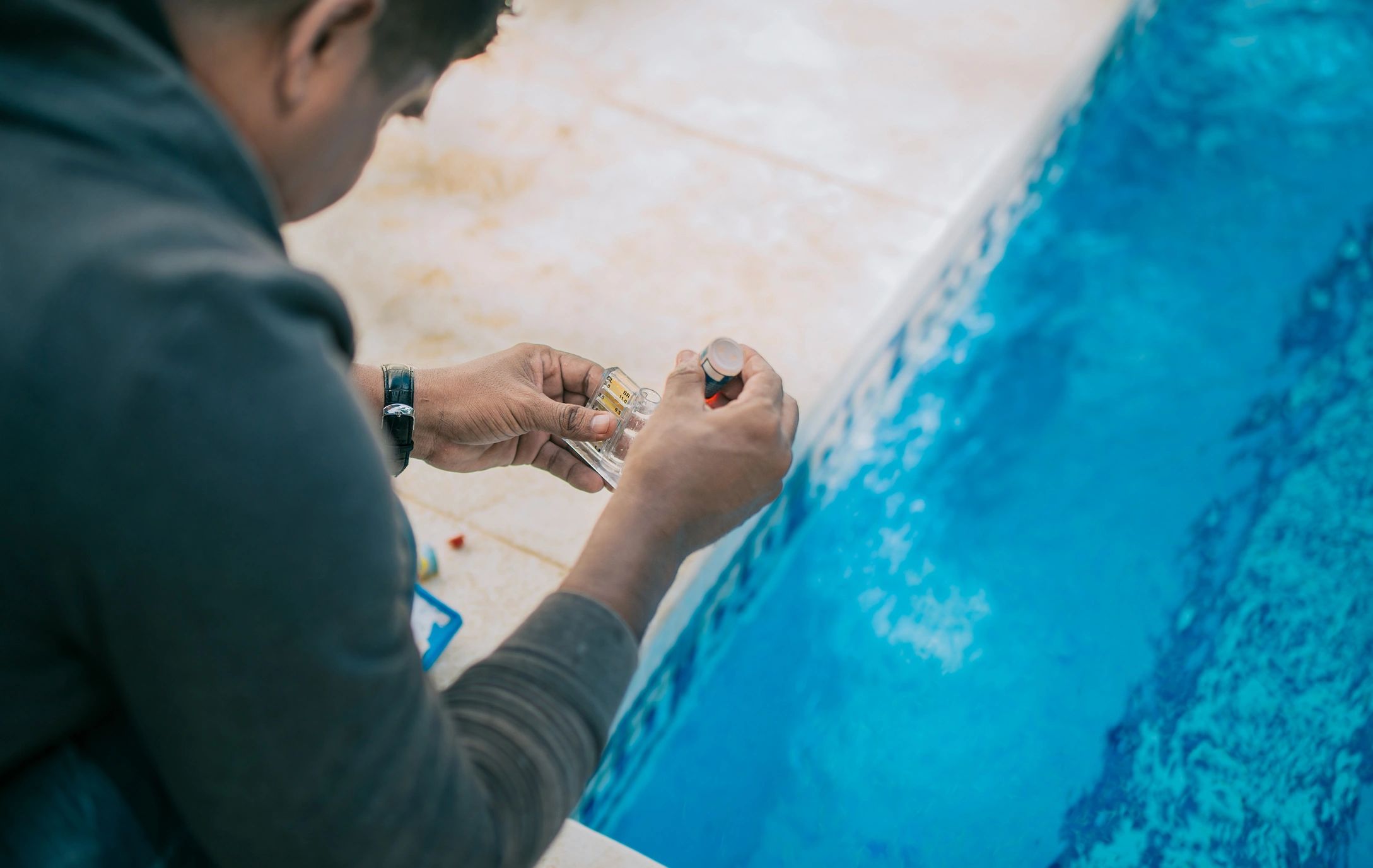 pool technician testing pool water with a test kit